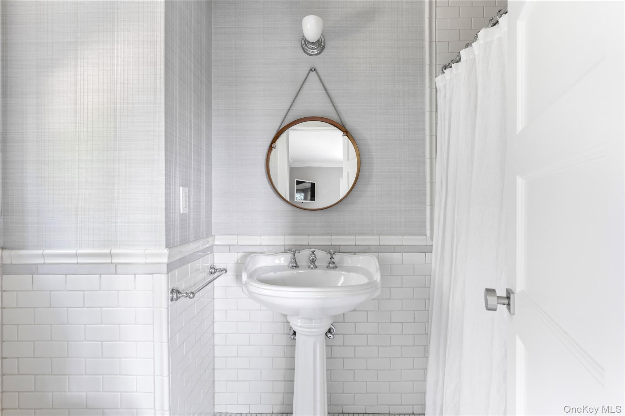 25 Soundview Lane Sands Point, NY 11050 - Photo 29 of 43 a bathroom with a sink a mirror and a shower