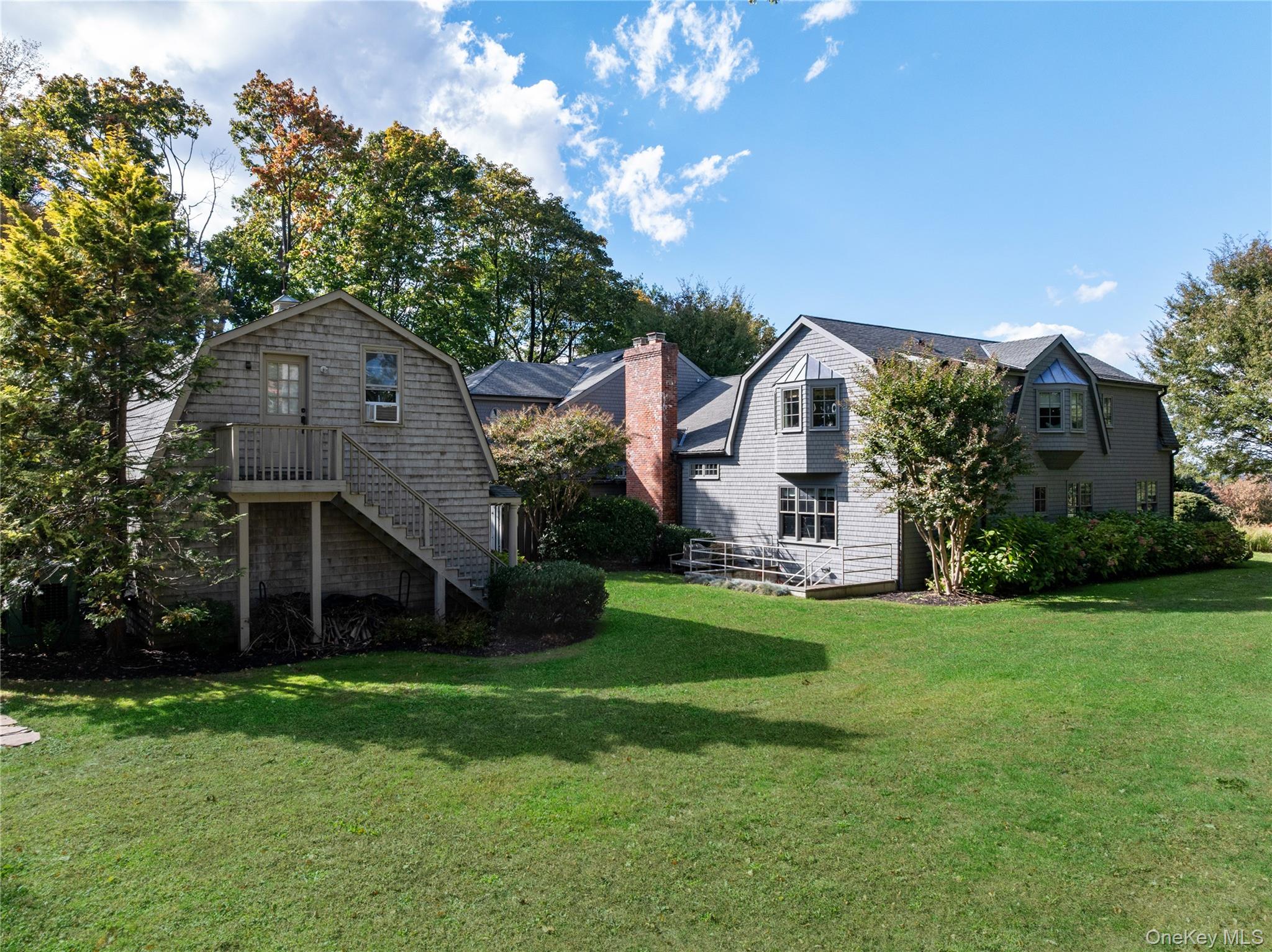 25 Soundview Lane Sands Point, NY 11050 - Photo 36 of 43 a front view of a house with a garden and trees