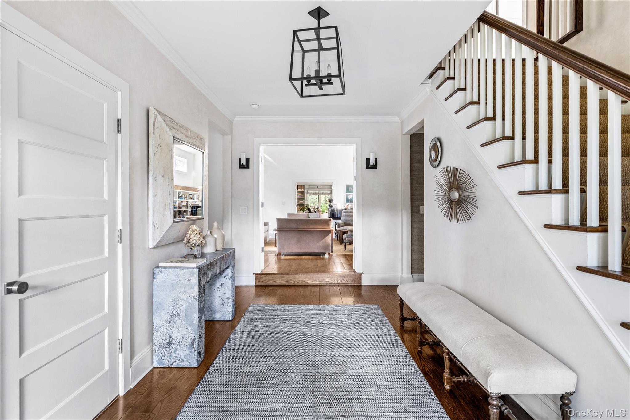 25 Soundview Lane Sands Point, NY 11050 - Photo 5 of 43 a view of a hallway with wooden floor and staircase