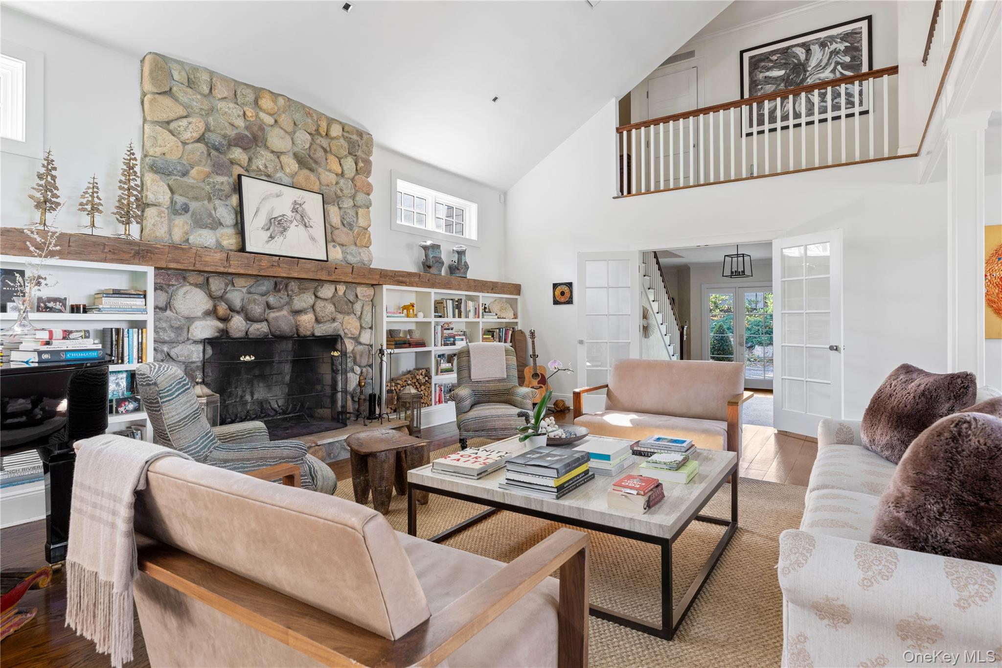 25 Soundview Lane Sands Point, NY 11050 - Photo 7 of 43 a living room with furniture a fireplace and a book shelf