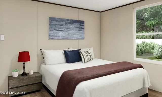 a bedroom with a bed and a lamp on table