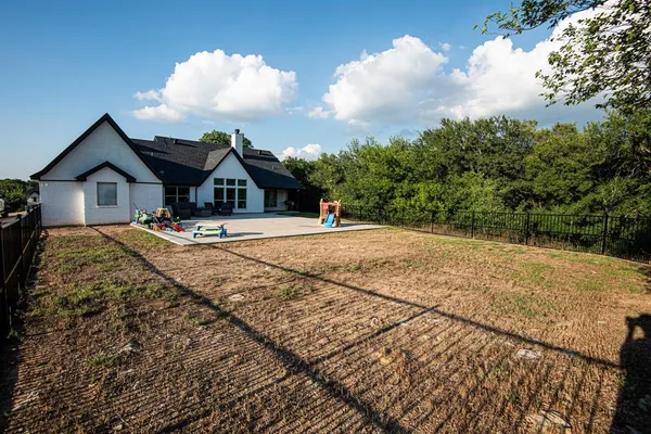 a front view of house with yard outdoor seating and barbeque oven