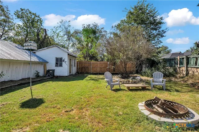 a swimming pool with some trees in the background