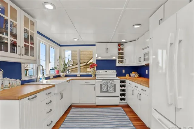 a kitchen with stainless steel appliances a sink stove and cabinets