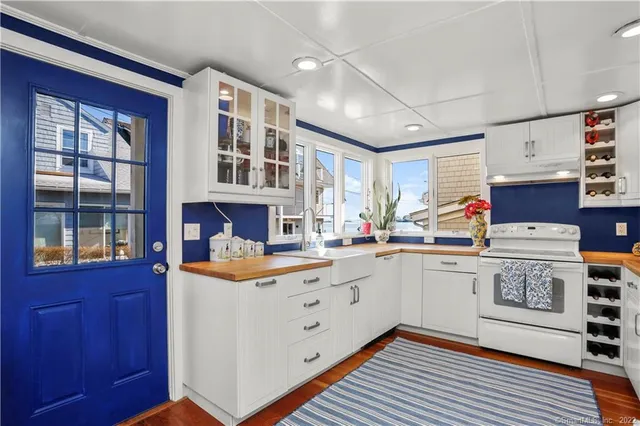 a kitchen with stainless steel appliances granite countertop a stove and a sink
