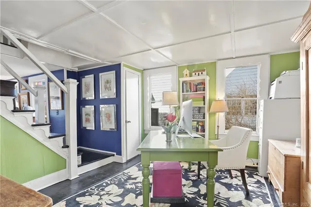 a front view of a dining room with furniture one side kitchen view and wooden floor