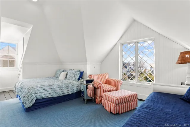 a bedroom with furniture and a large window