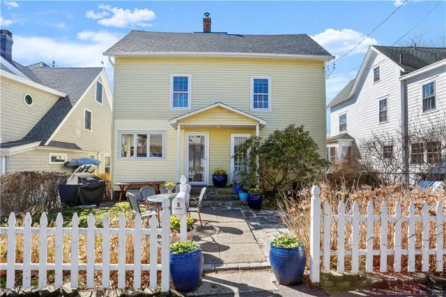 a front view of house with yard outdoor seating and barbeque oven