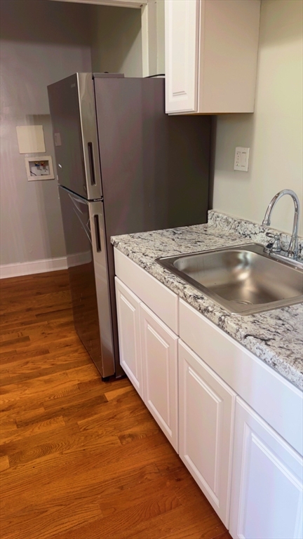 118 Longhill Street, Unit 3 Springfield, MA 01108 - Photo 12 of 24 a kitchen with a sink and refrigerator