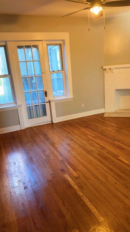 118 Longhill Street, Unit 3 Springfield, MA 01108 - Photo 17 of 24 a view of an empty room with wooden floor and a window