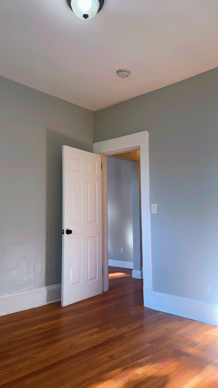 118 Longhill Street, Unit 3 Springfield, MA 01108 - Photo 22 of 24 a view of an empty room with wooden floor