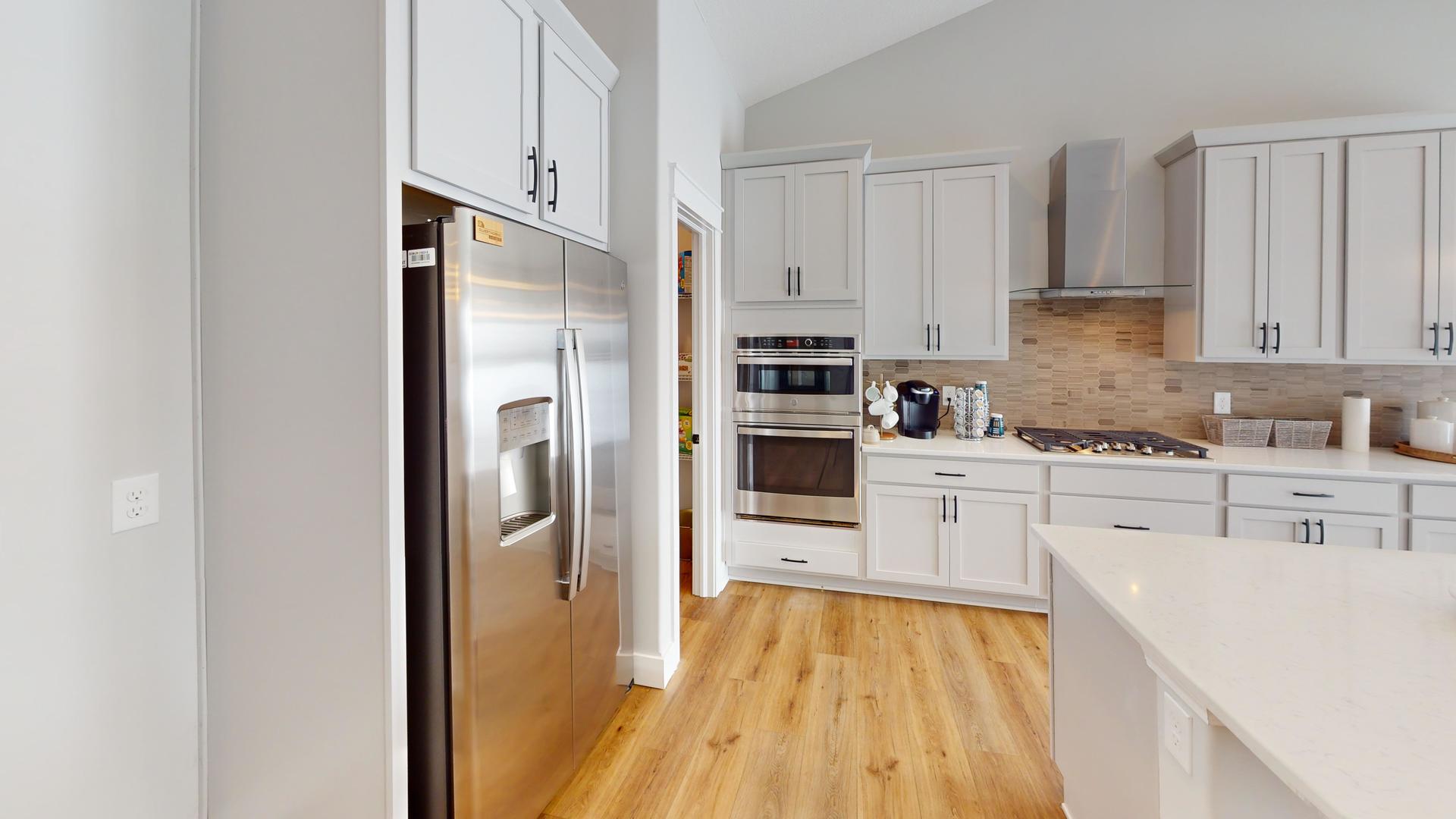 8-2 West Orchid Lane, Unit 2 Channahon, IL 60410 - Photo 20 of 28 a kitchen with stainless steel appliances a refrigerator sink and cabinets