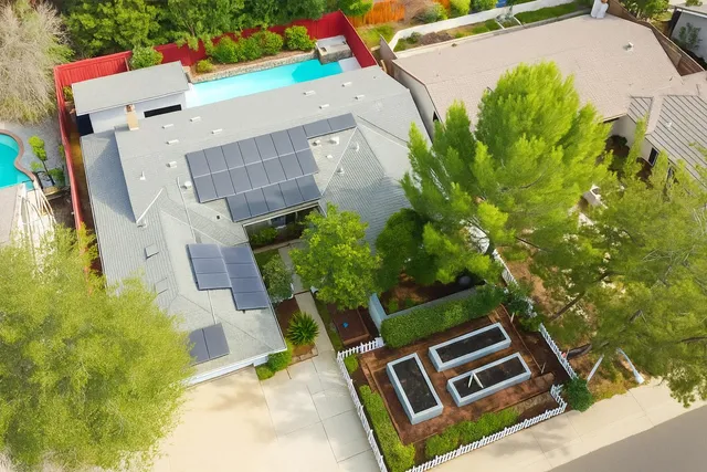 an aerial view of a house with a yard