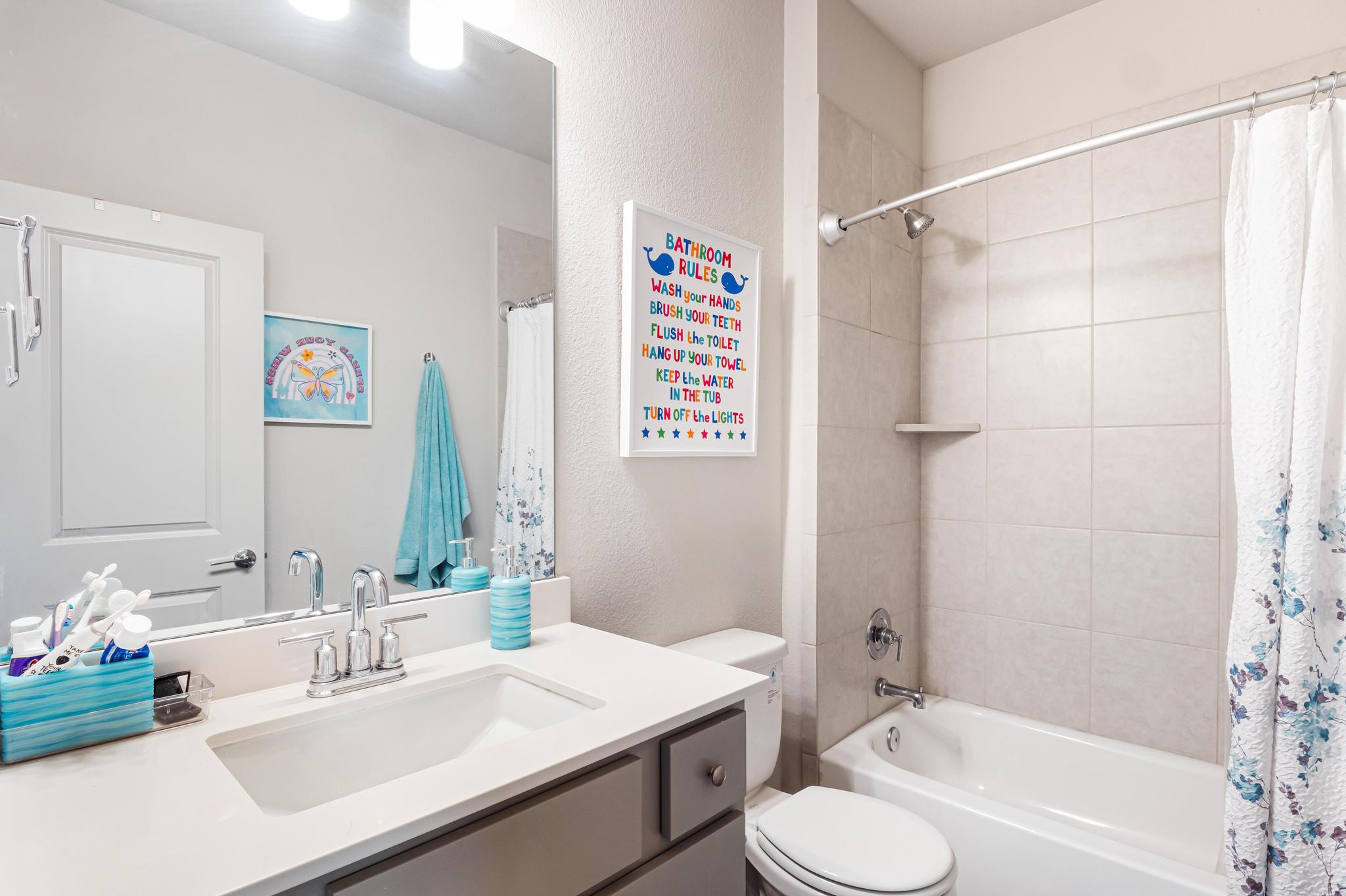 2301 Local Rebel Street Leander, TX 78641 - Photo 20 of 21 a bathroom with a sink vanity mirror and a bathtub