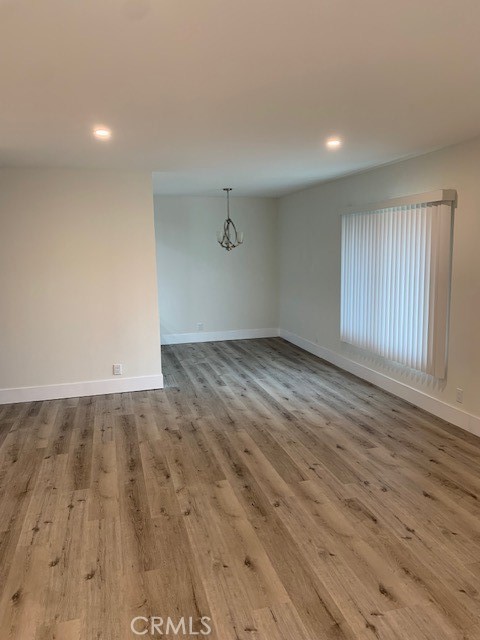 2275 Hazel Road Tustin, CA 92780 - Photo 3 of 25 an empty room with wooden floor and windows