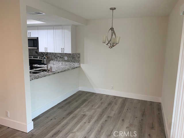 2275 Hazel Road Tustin, CA 92780 - Photo 4 of 25 a kitchen with a refrigerator and cabinets