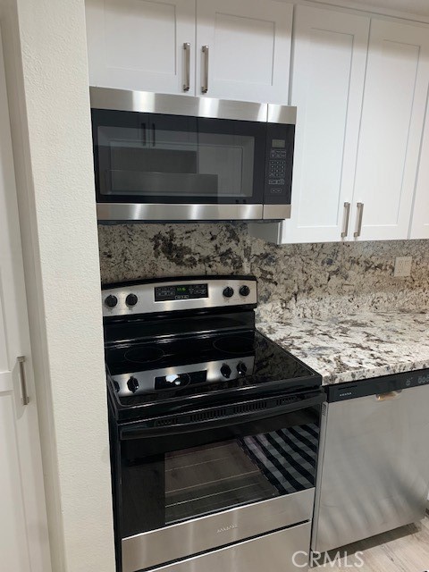 2275 Hazel Road Tustin, CA 92780 - Photo 6 of 25 a stove top oven sitting inside of a kitchen