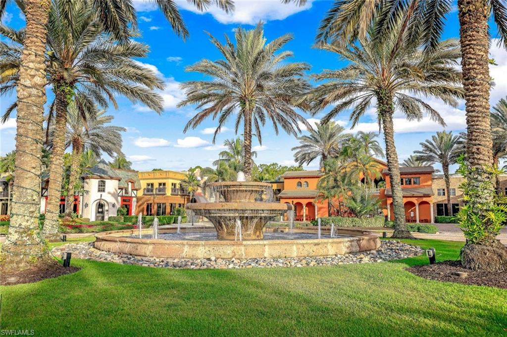 9115 Capistrano Street South, Unit 8207 Naples, FL 34113 - Photo 1 of 29 a view of a swimming pool with a garden