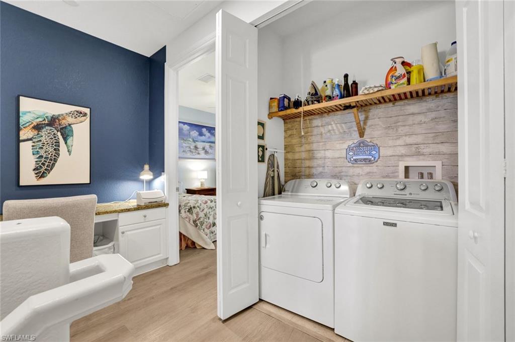 9115 Capistrano Street South, Unit 8207 Naples, FL 34113 - Photo 17 of 29 a view of washer and dryer with kitchen flooring