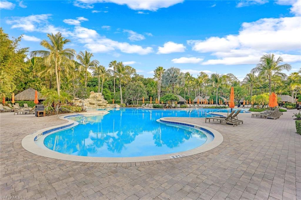 9115 Capistrano Street South, Unit 8207 Naples, FL 34113 - Photo 18 of 29 a view of a swimming pool with outdoor seating
