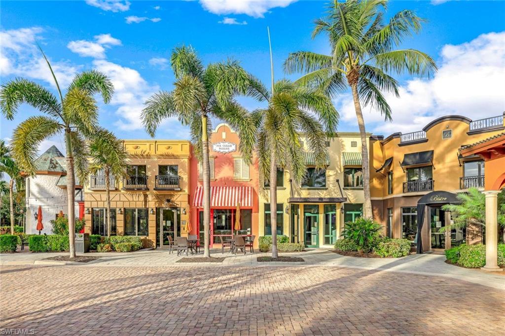 9115 Capistrano Street South, Unit 8207 Naples, FL 34113 - Photo 25 of 29 a city street lined with buildings and trees