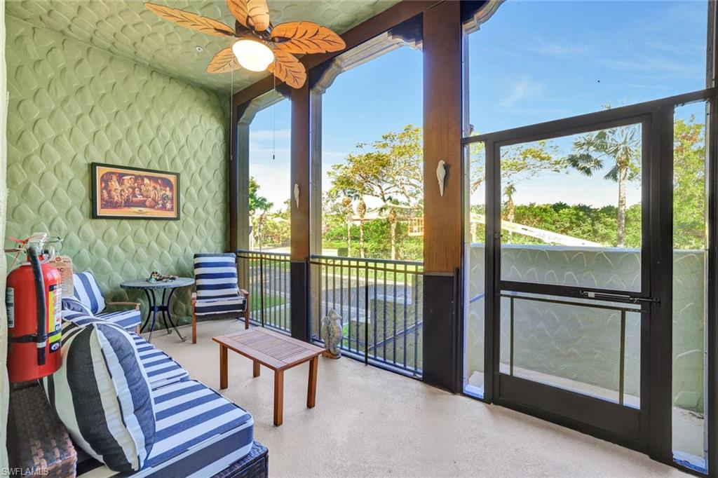 9115 Capistrano Street South, Unit 8207 Naples, FL 34113 - Photo 3 of 29 a view of a livingroom with furniture and a flat screen tv