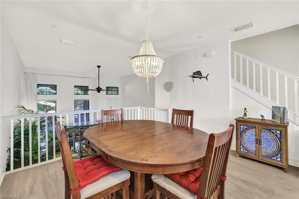 9115 Capistrano Street South, Unit 8207 Naples, FL 34113 - Photo 7 of 29 a view of a dining room with furniture