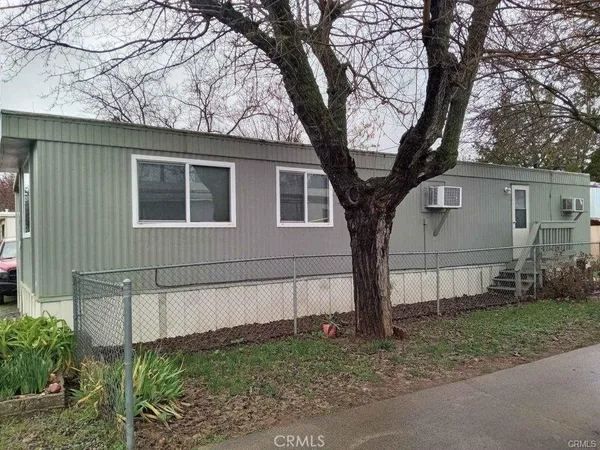 a view of a house with a large tree and a big yard