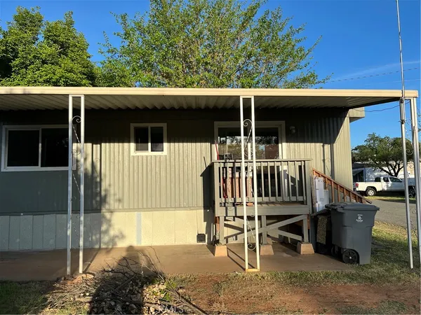 a view of a chair and tables in the balcony