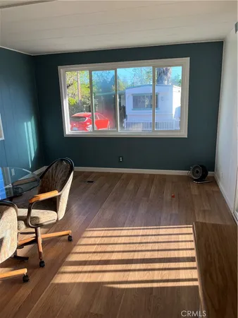 a room with wooden floor and windows