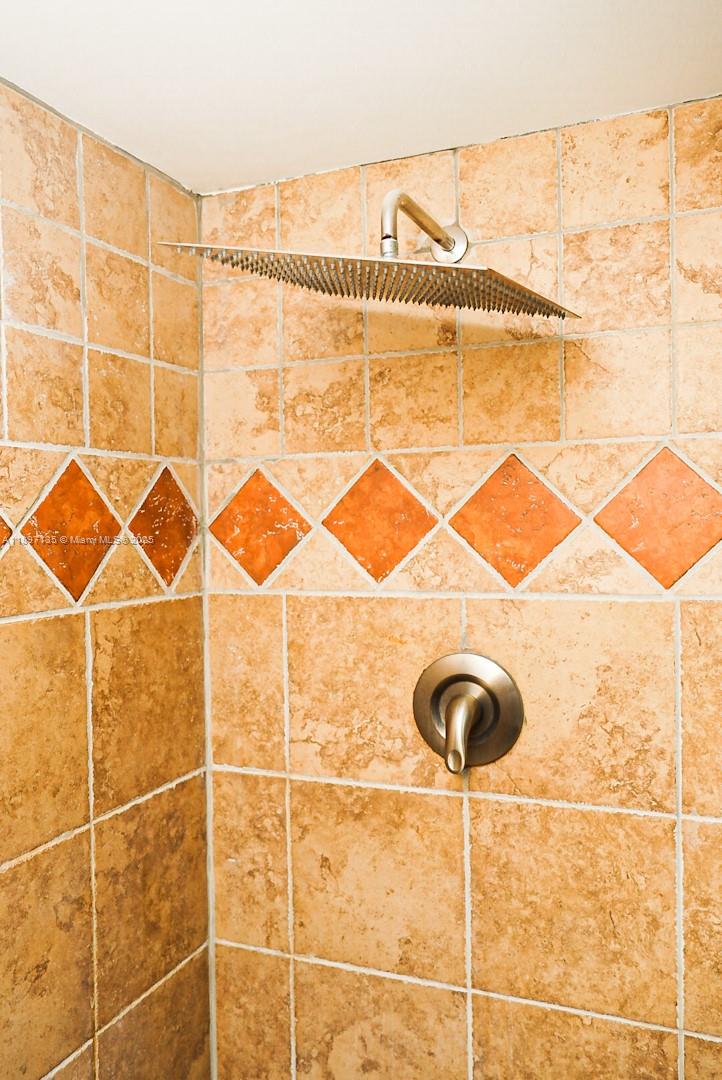 100 Golden Isles Drive, Unit 10 Hallandale Beach, FL 33009 - Photo 13 of 18 a bathroom with a sink and a shower