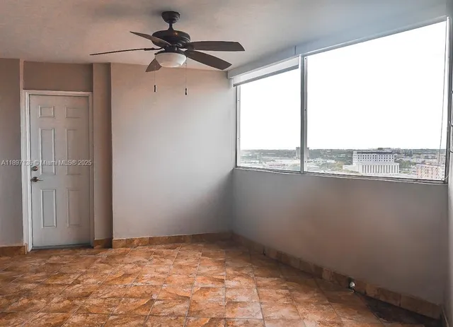 a view of an empty room with a window