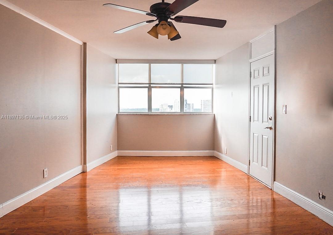 100 Golden Isles Drive, Unit 10 Hallandale Beach, FL 33009 - Photo 9 of 18 wooden floor in an empty room with a window