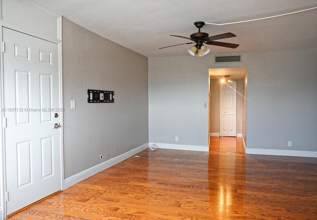 100 Golden Isles Drive, Unit 10 Hallandale Beach, FL 33009 - Photo 10 of 18 a view of empty room with wooden floor