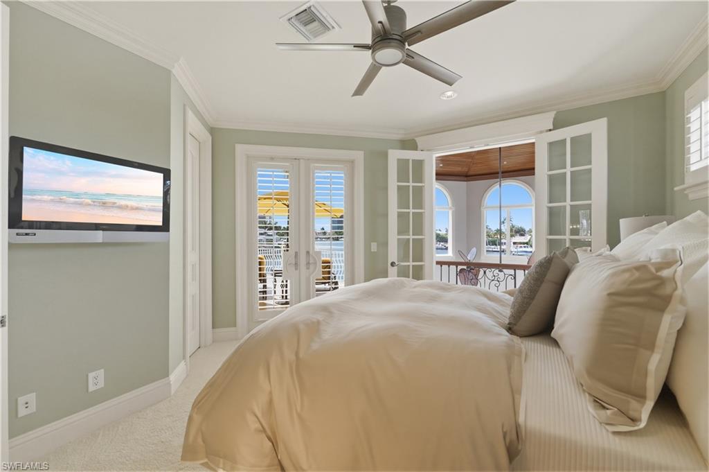 361 Pirates Bight Naples, FL 34103 - Photo 31 of 45 a spacious bedroom with a bed and glass door