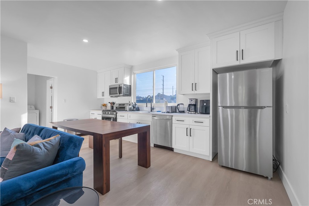 3115 Arvia Street, Unit 1B Los Angeles, CA 90065 - Photo 11 of 27 a kitchen with white cabinets and refrigerator