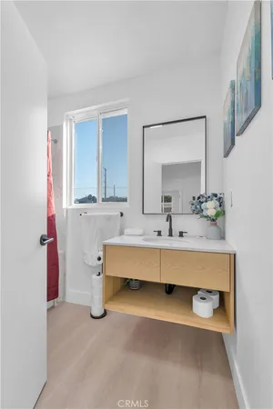 a bathroom with a sink mirror and a bathtub