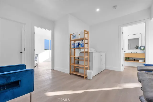 a view of a livingroom with wooden floor and cabinet