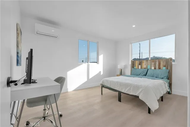 a bedroom with a bed table and chair