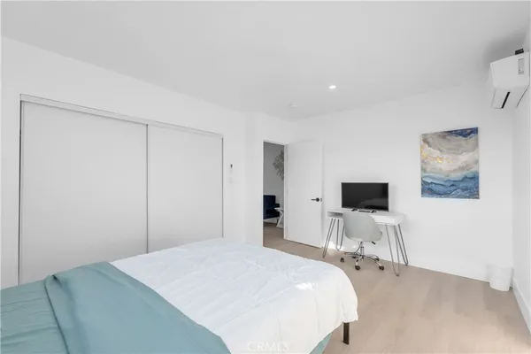 a bedroom with a bed and a flat screen tv