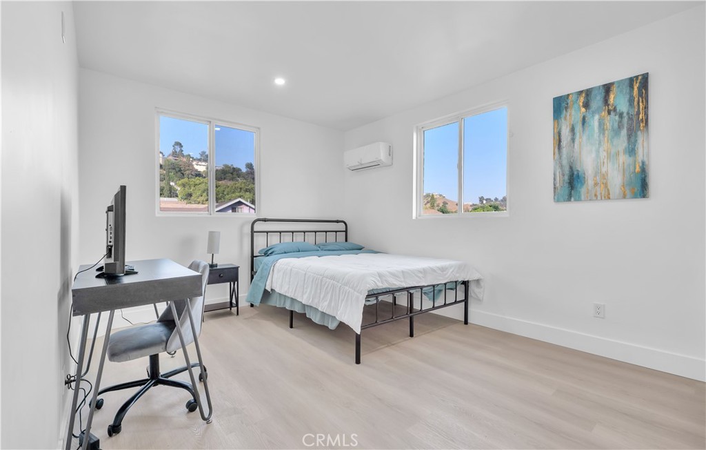 3115 Arvia Street, Unit 1B Los Angeles, CA 90065 - Photo 22 of 27 a spacious bedroom with a bed and a table in it