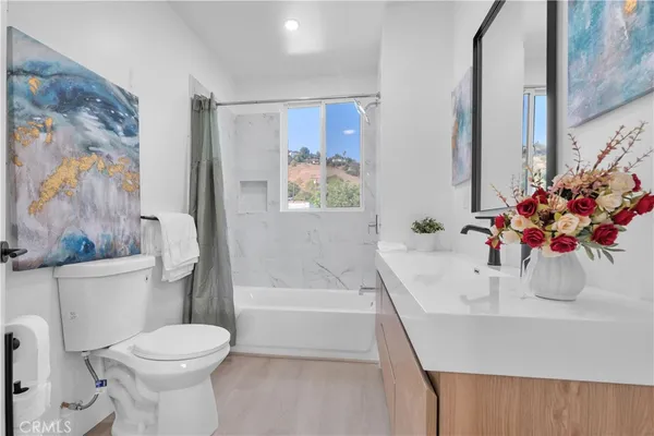 a bathroom with a sink toilet and shower