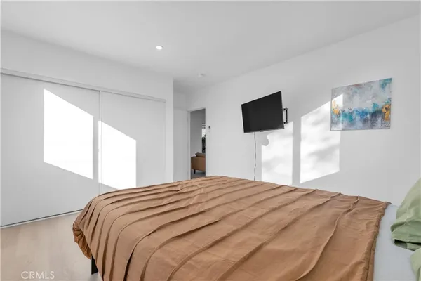 a bedroom with a bed and a flat screen tv