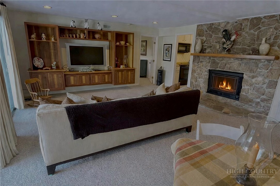 638 Ridge Road Glade Valley, NC 28627 - Photo 28 of 44 a living room with furniture and a fireplace