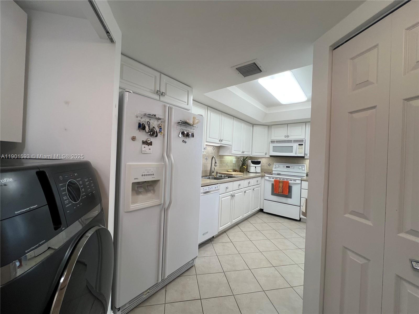 520 Brickell Key Drive, Unit A900 Miami, FL 33131 - Photo 16 of 58 a kitchen with stainless steel appliances a refrigerator sink and cabinets