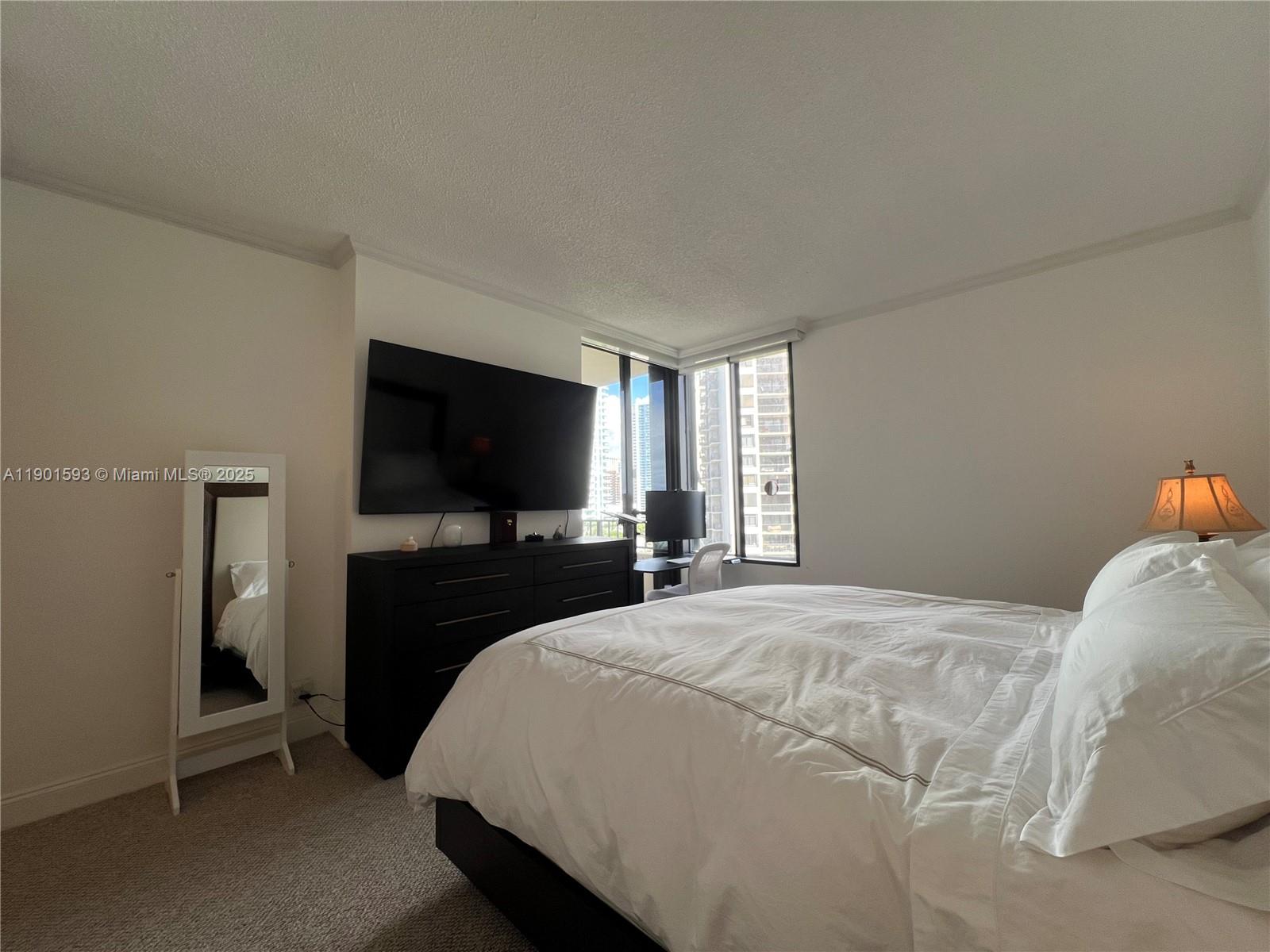 520 Brickell Key Drive, Unit A900 Miami, FL 33131 - Photo 19 of 58 a bedroom with a bed and a flat screen tv