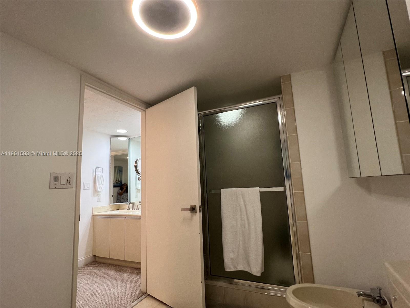 520 Brickell Key Drive, Unit A900 Miami, FL 33131 - Photo 21 of 58 a bathroom with a toilet and a mirror