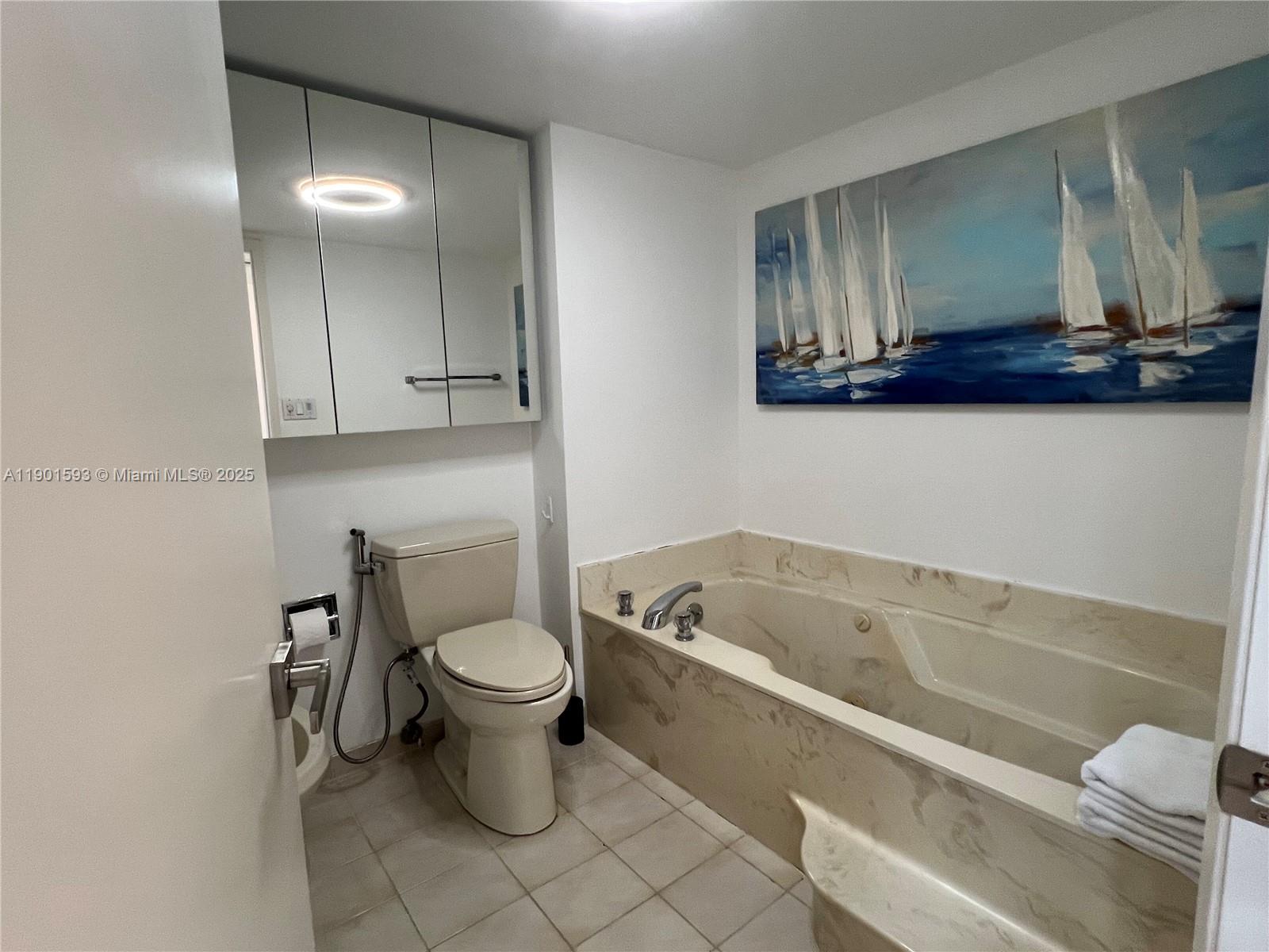 520 Brickell Key Drive, Unit A900 Miami, FL 33131 - Photo 23 of 58 a bathroom with a toilet sink and mirror