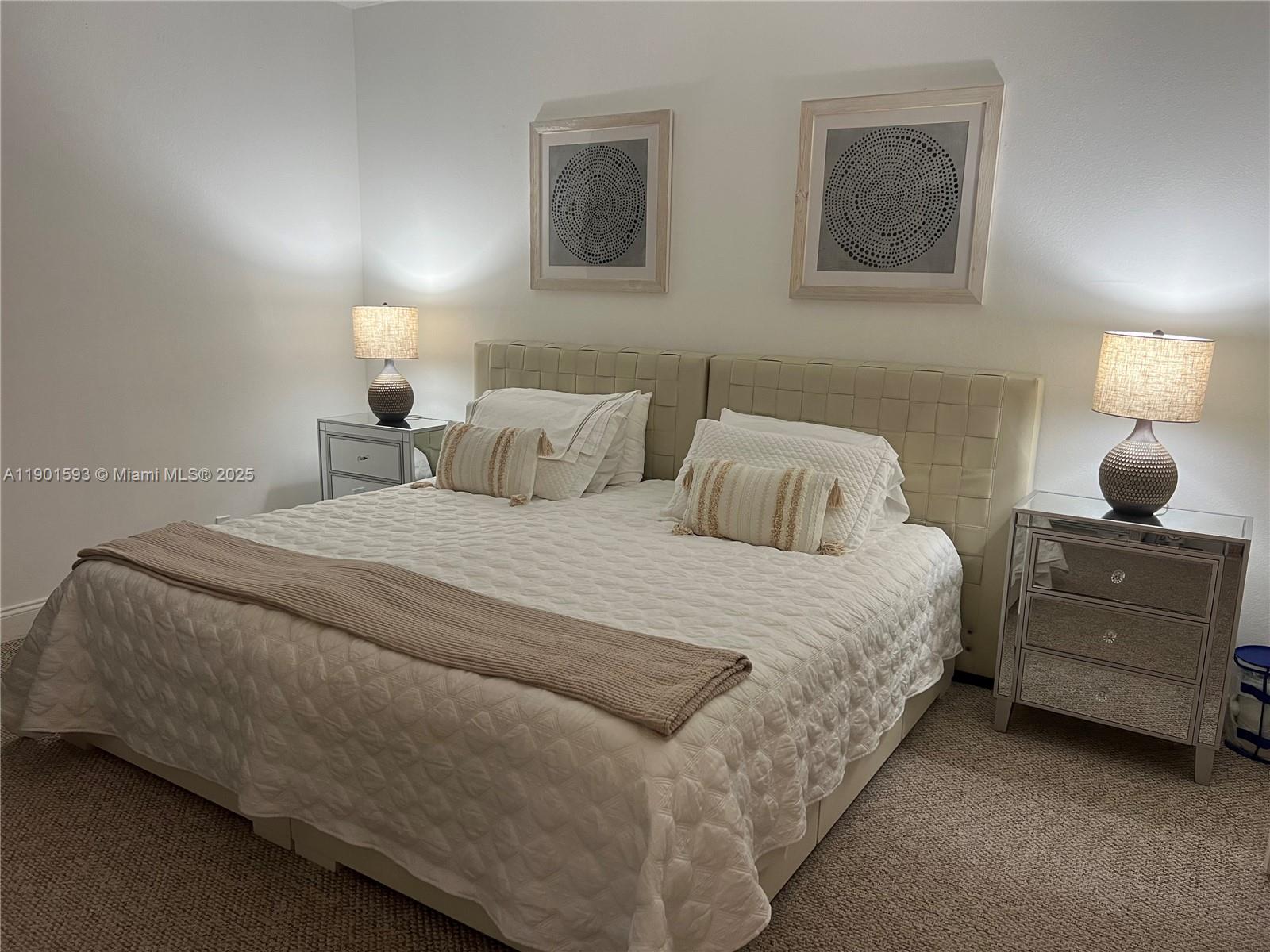 520 Brickell Key Drive, Unit A900 Miami, FL 33131 - Photo 25 of 58 a bedroom with a bed and lamp