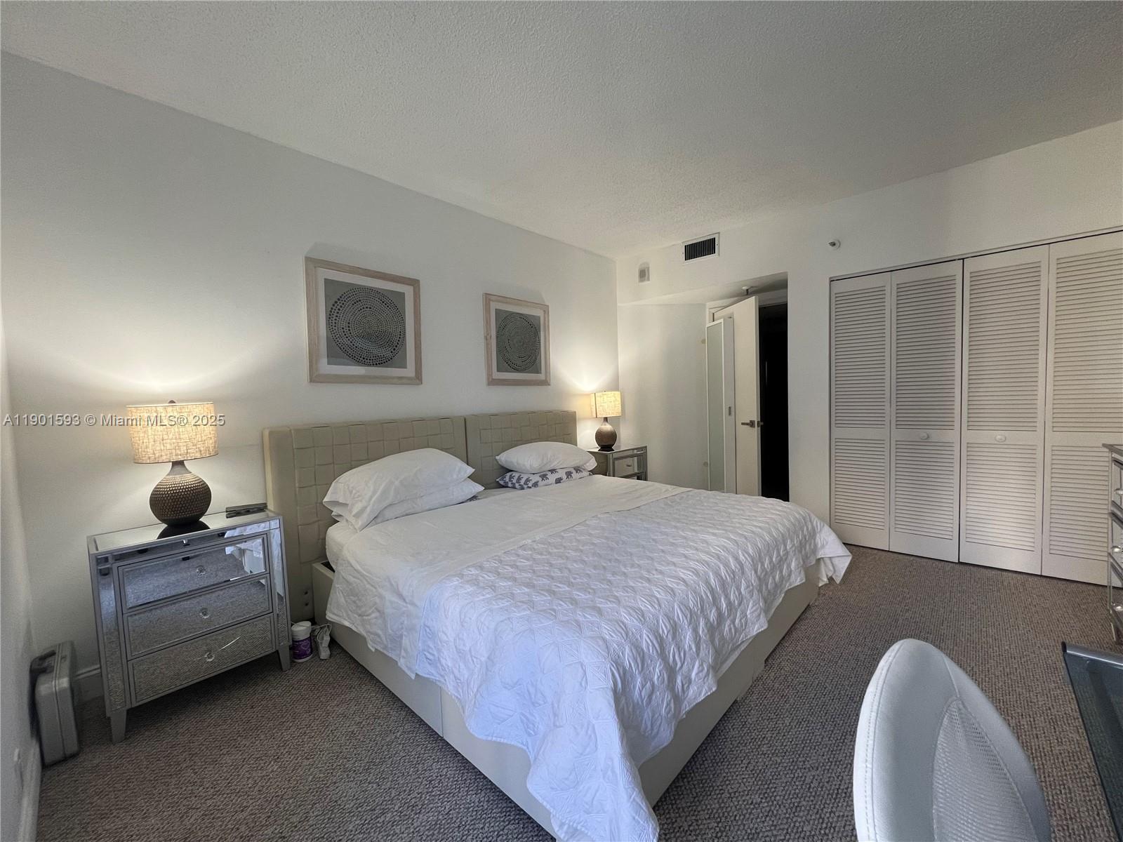 520 Brickell Key Drive, Unit A900 Miami, FL 33131 - Photo 26 of 58 a bedroom with bed and window